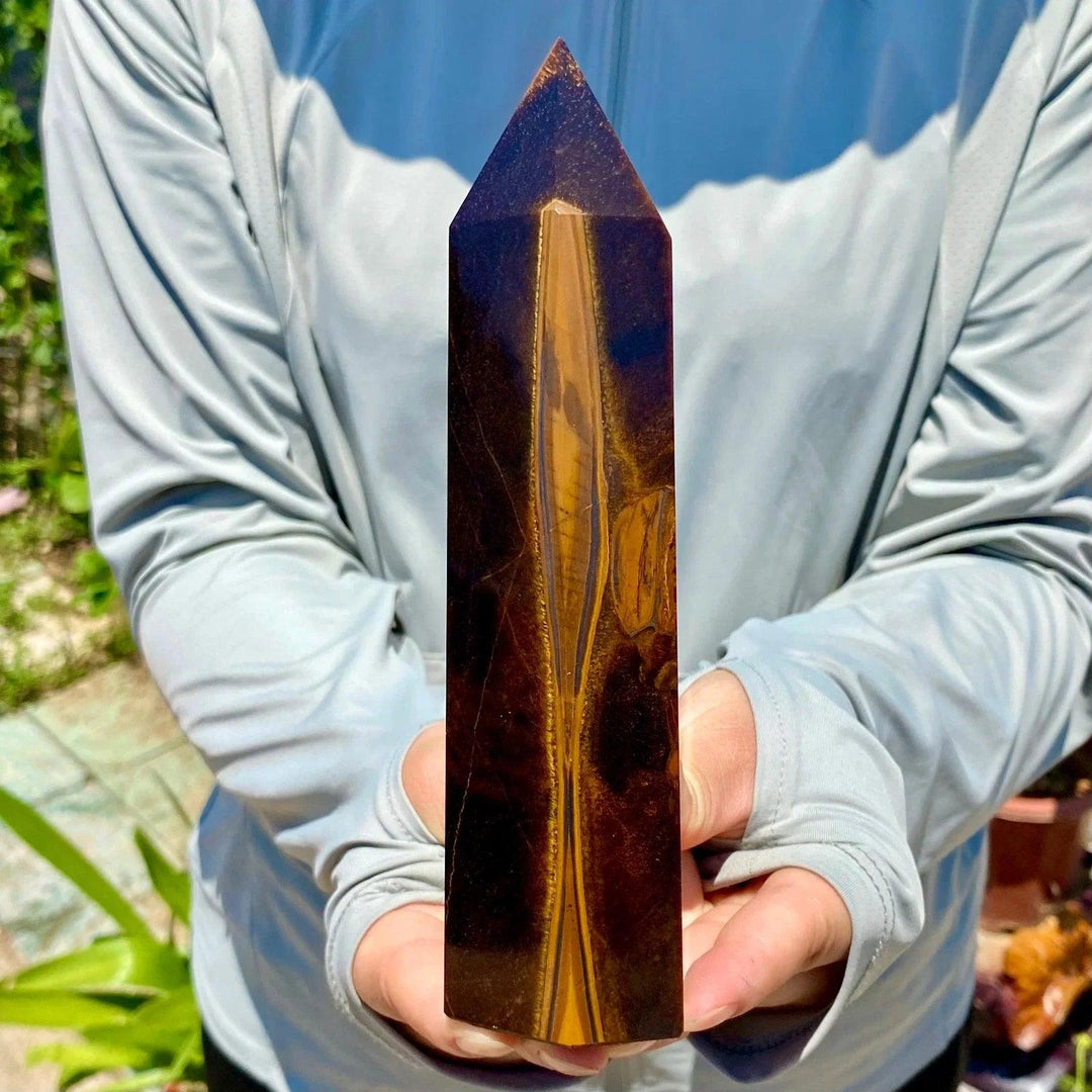 Polished Yellow Tiger's Eye obelisk crystal wand with golden-brown chatoyant bands for healing and meditation.