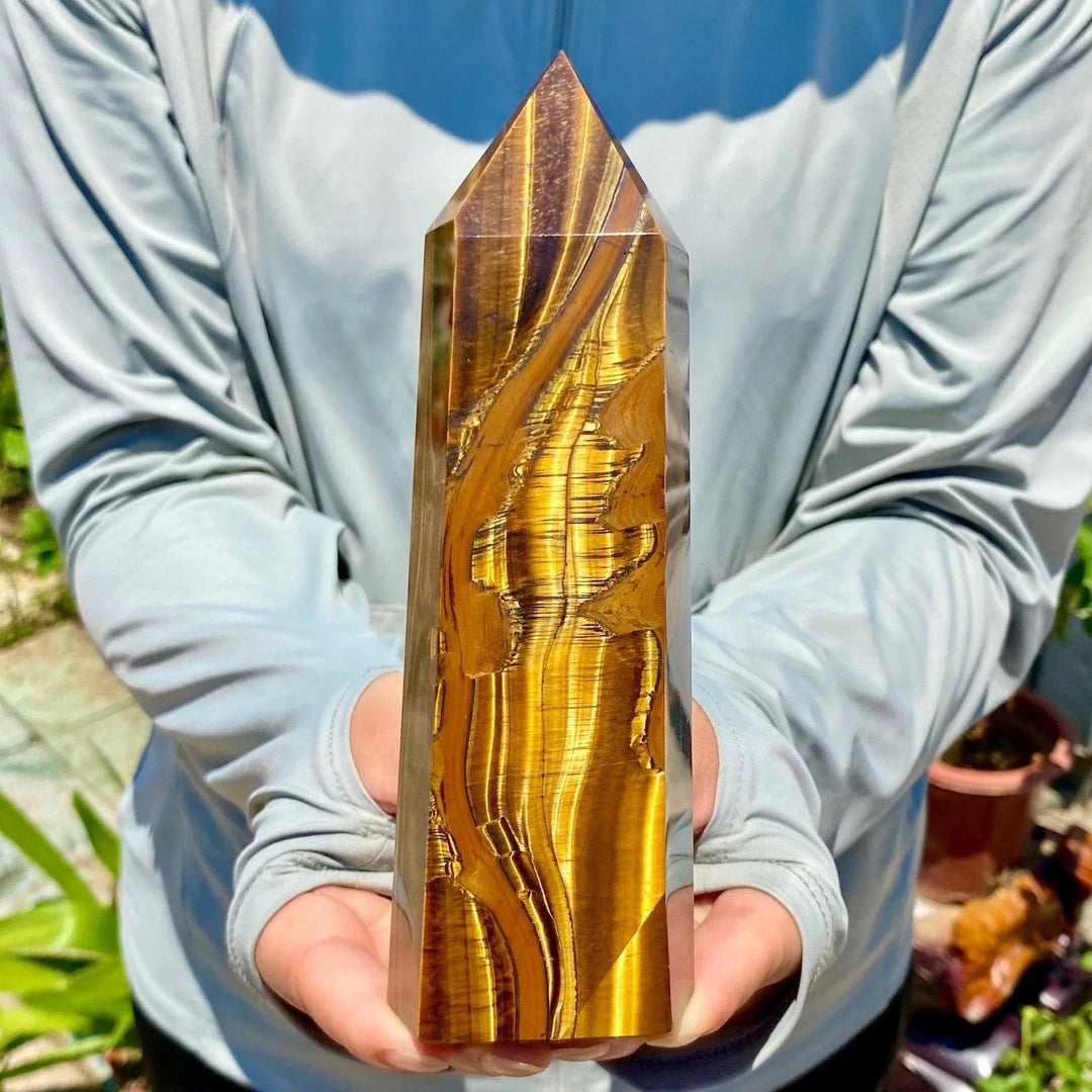 Polished yellow Tiger's Eye obelisk crystal wand with golden chatoyant bands, perfect for healing and home decor.