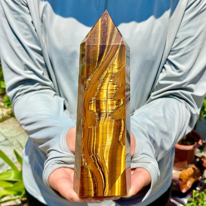 Polished yellow Tiger's Eye obelisk crystal wand with golden chatoyant bands, perfect for healing and home decor.