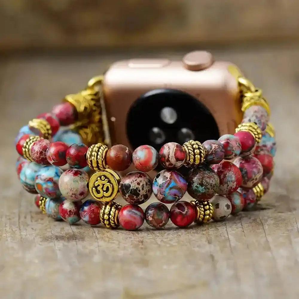 Crystal Destiny Imperial Jasper beaded Apple Watch band with Om charm, red, blue, and earthy tones, for grounding energy.
