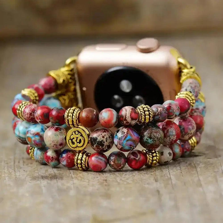 Crystal Destiny Imperial Jasper beaded Apple Watch band with Om charm, red, blue, and earthy tones, for grounding energy.
