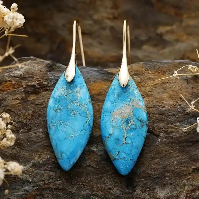 Imperial Jasper Crystal Drop Earrings: Marquise-cut turquoise stones with gold hooks, offering grounding and emotional balance.