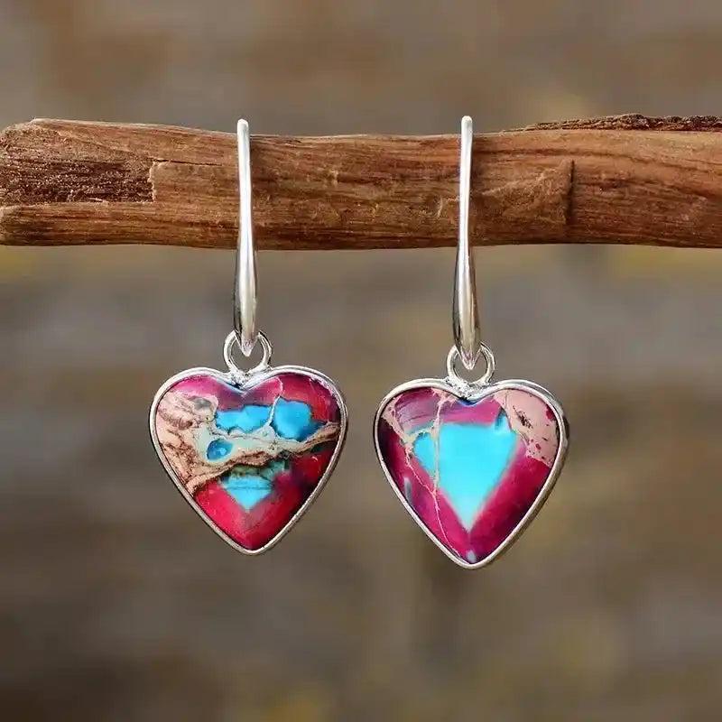 Heart-Shaped 7 Chakra Drop Earrings: Vibrant pink and blue healing stone hearts in silver-plated settings, promoting balance.