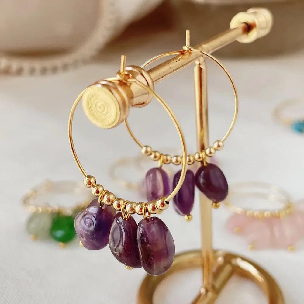 Irregular Amethyst Crystal Stone Dangle Hoop Earrings for Women, featuring raw purple stones on gold hoops.