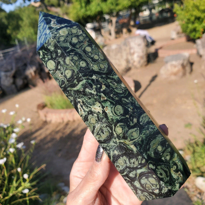 Kambaba Jasper Crystal Point Tower, a grounding hexagonal obelisk with deep green swirls and black orbs.