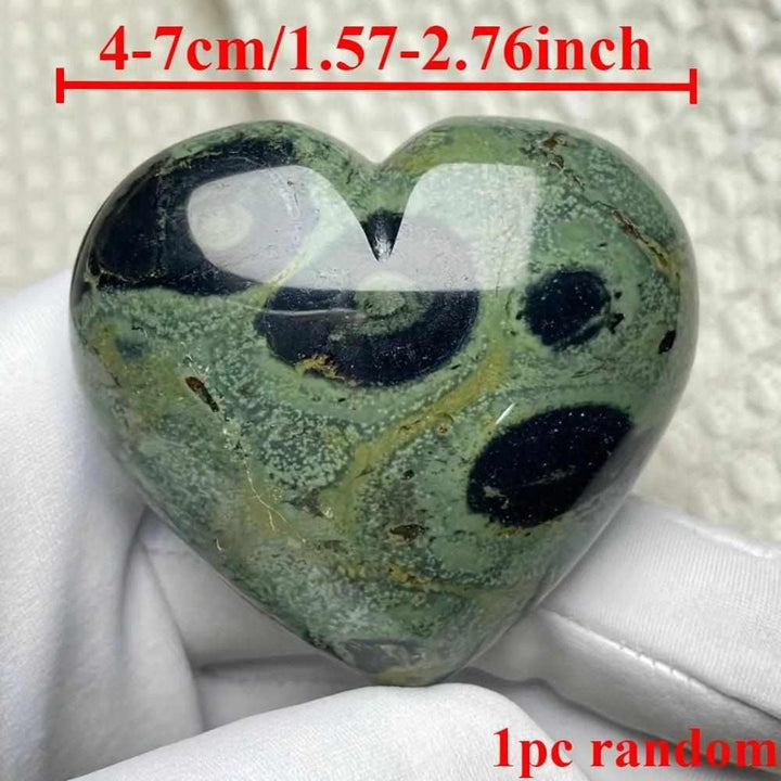 Polished Kambaba Jasper heart featuring deep green and black orb patterns, perfect for grounding and heart chakra healing.