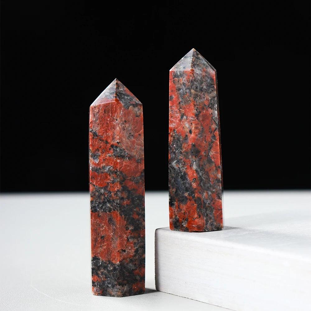 Two polished Katophorite crystal towers with striking red and black patterns for energy healing and home decor.