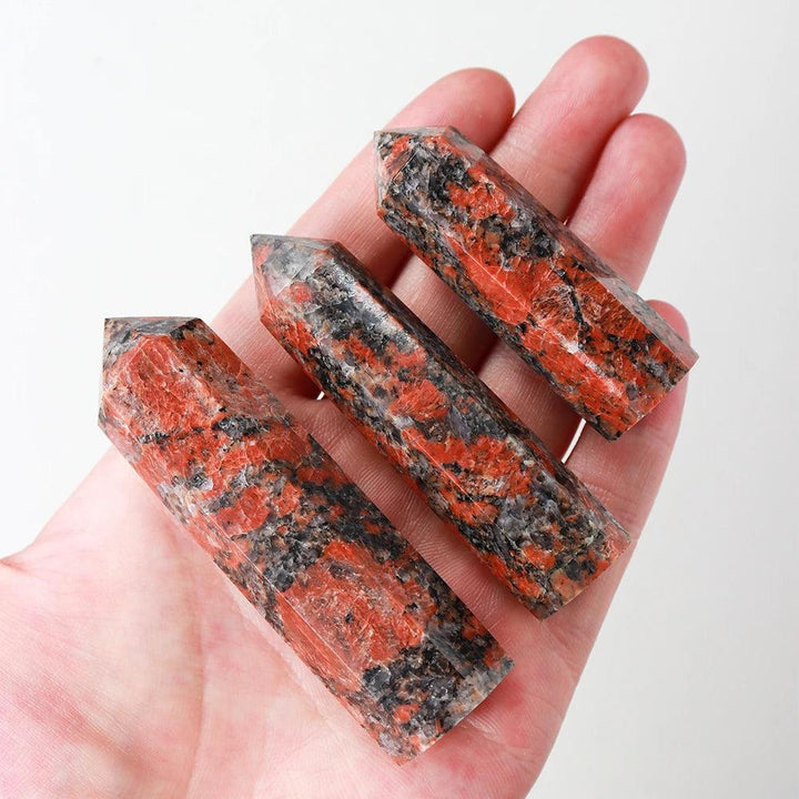 Three polished Katophorite crystal towers with vibrant red and black speckled patterns for energy healing and meditation.