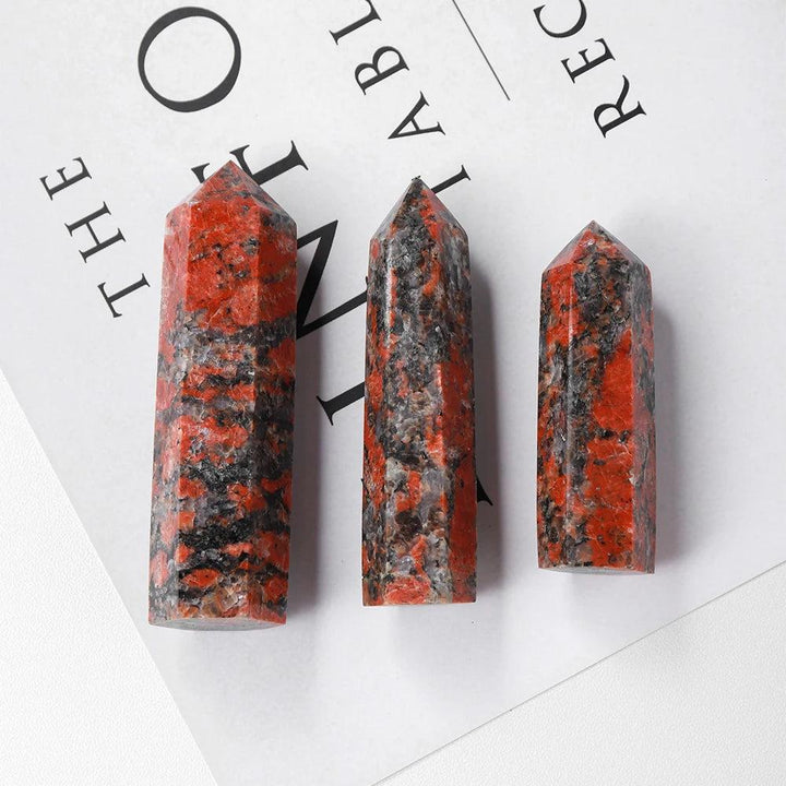 Three polished Katophorite stone towers with vibrant red and black patterns for energy healing and home decor.