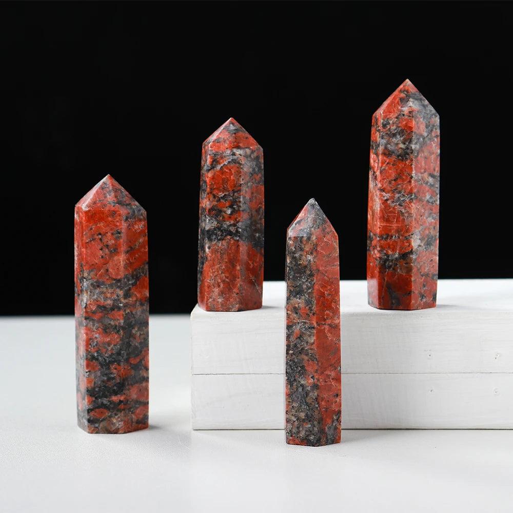 Natural Katophorite gemstone towers in hexagonal prism shapes, featuring striking red and black energy healing crystals.