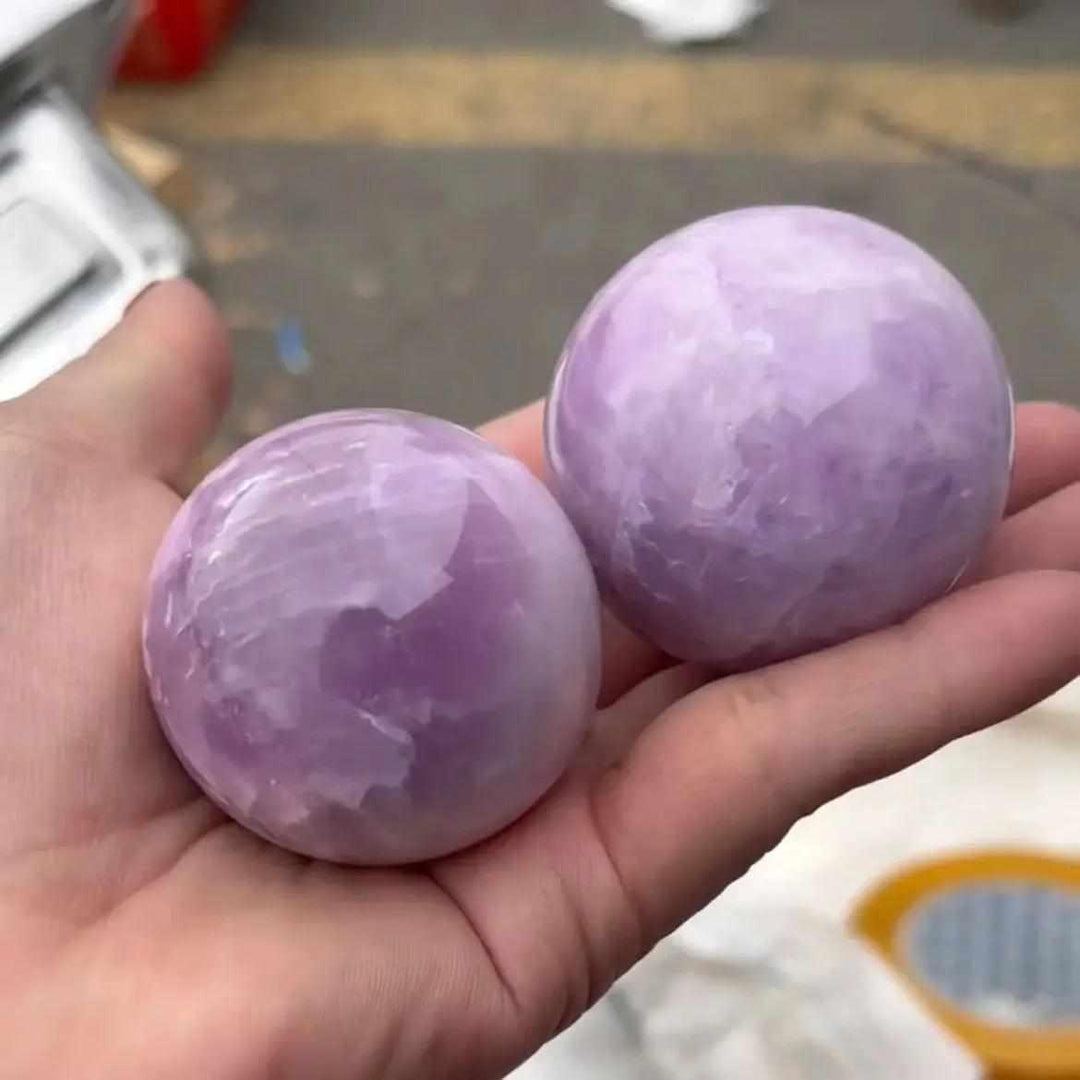 Two polished Kunzite spheres in soft pink and lilac, perfect for heart chakra healing and emotional calm.
