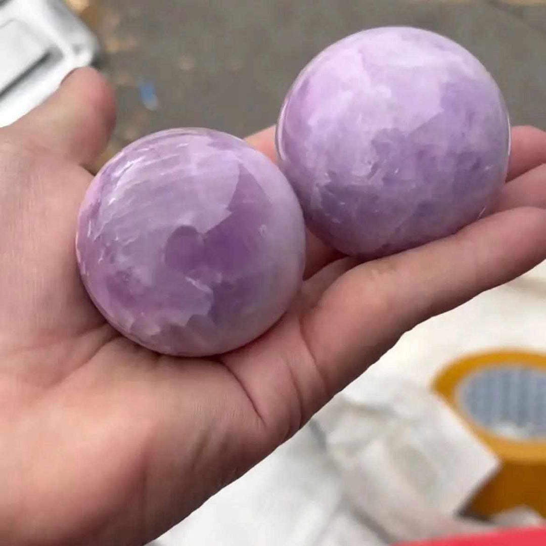 Two polished Kunzite spheres in soft pink and lilac, perfect for heart chakra meditation and emotional calm.