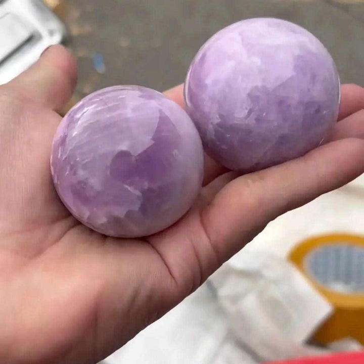 Two polished Kunzite spheres in soft pink and lilac, perfect for heart chakra meditation and emotional calm.