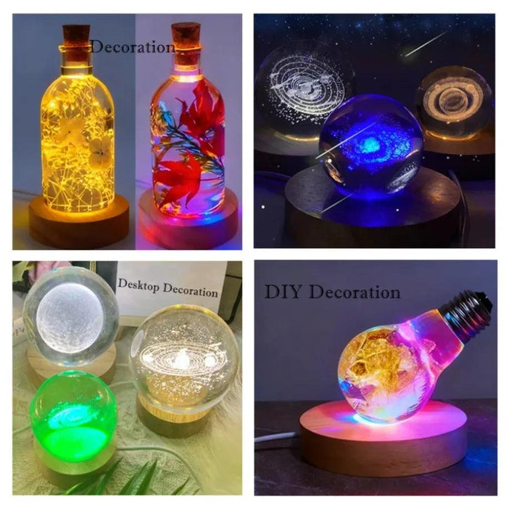 Wooden LED light bases illuminating various crystal spheres, bottles, and a lightbulb with colorful glow.