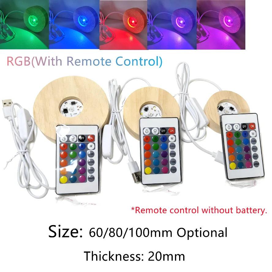 Three round wooden LED light bases with USB cables and RGB remote controls, shown with various crystal illumination effects.