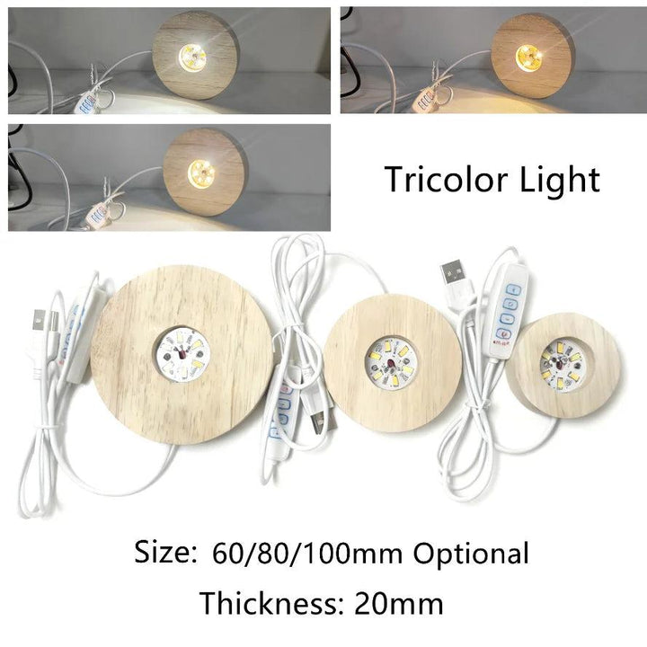 Three round wooden LED light bases with USB cables, showing white, warm, and tricolor light modes.