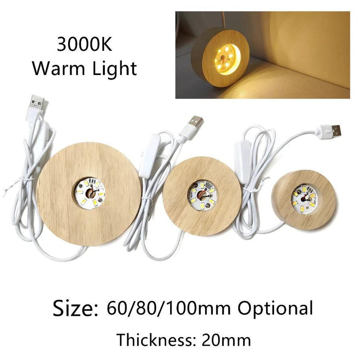 Three round wooden LED light bases with USB cables, showing warm light and different sizes.