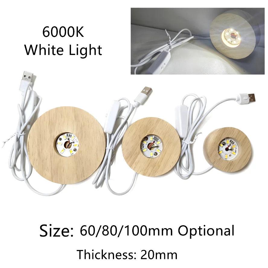 Three round wooden LED light bases with USB cords, showing 6000K white light, for illuminating crystals.