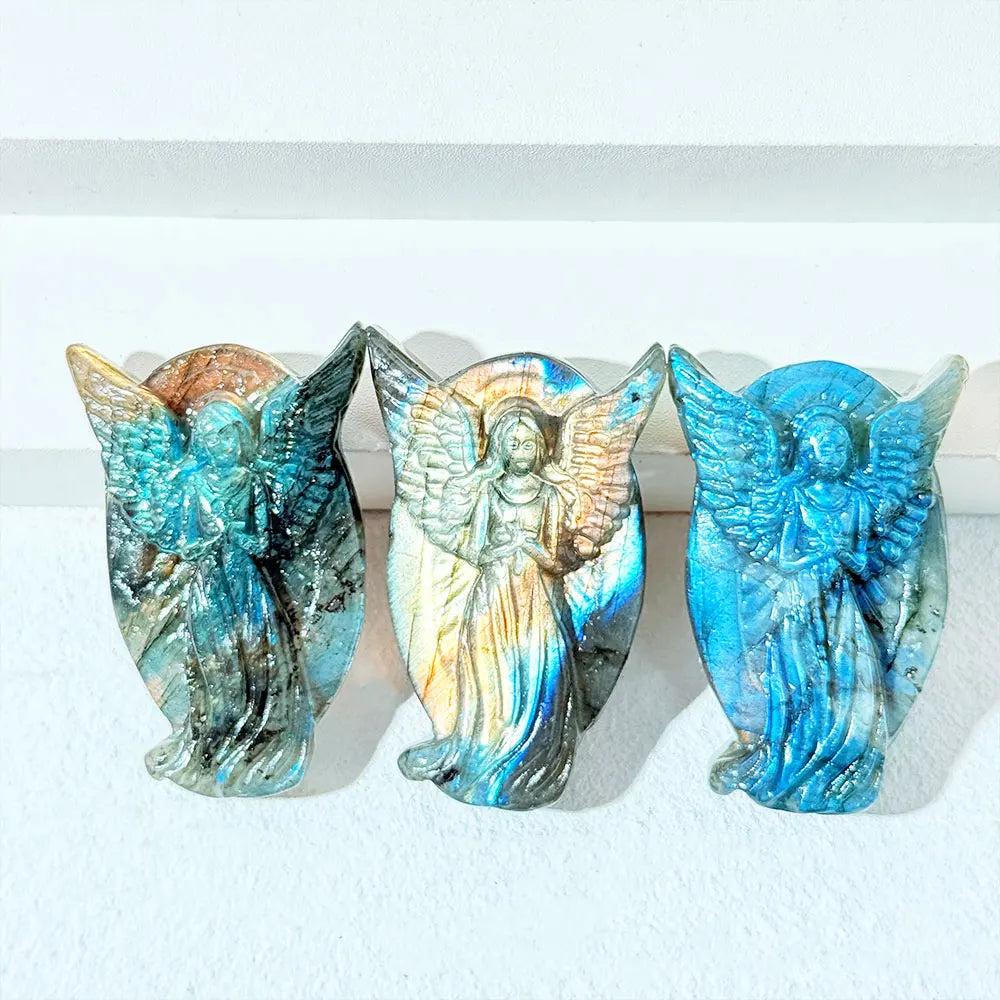 Three hand-carved Labradorite angel figurines with iridescent blue and gold flashes, perfect for healing home decor.