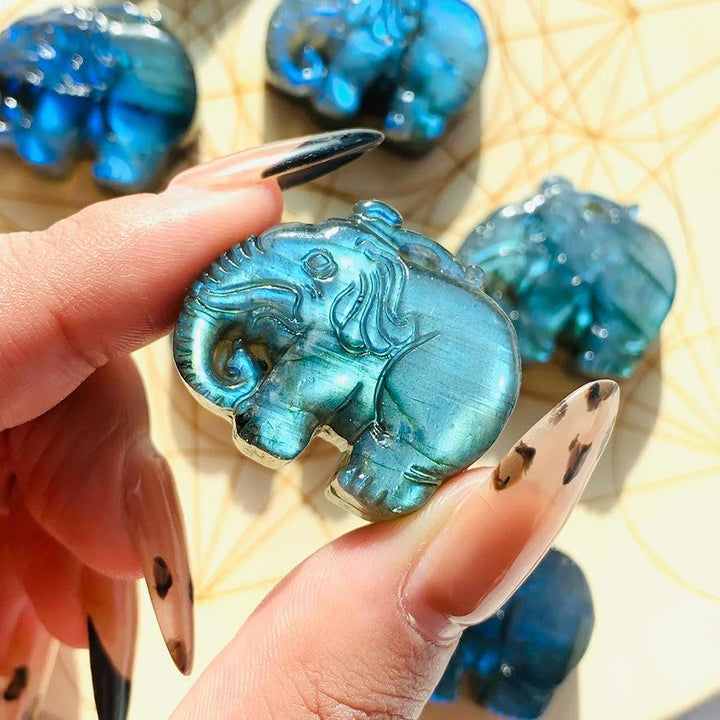 Handmade Labradorite elephant carving featuring vibrant blue and golden flash for spiritual healing and home decor.
