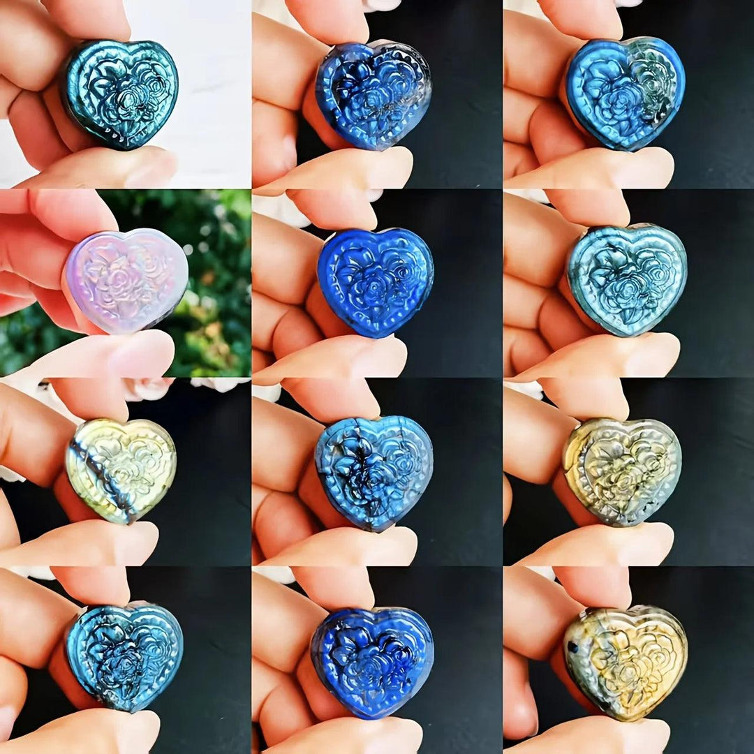 Polished Labradorite heart pendant with intricate floral carving, showcasing iridescent blue, green, and gold flashes.