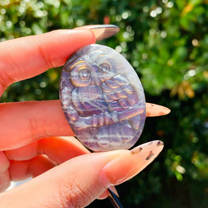 Handcrafted Labradorite owl carving featuring vibrant purple radiance and unique, flashy natural crystal energy.
