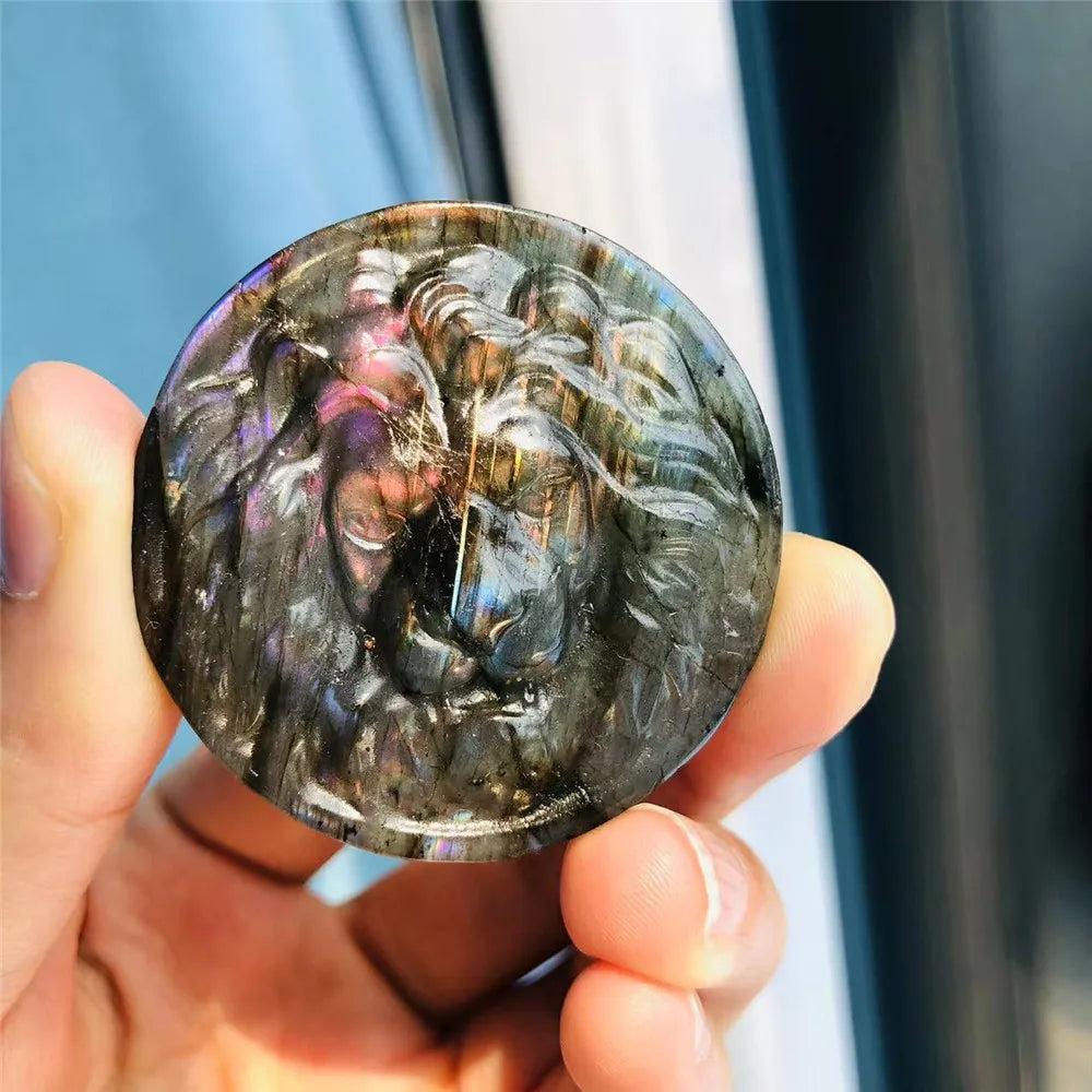 Labradorite Crystal Carved Polished Lion Head Carving, iridescent blues, greens, and golds flash on a dark stone.