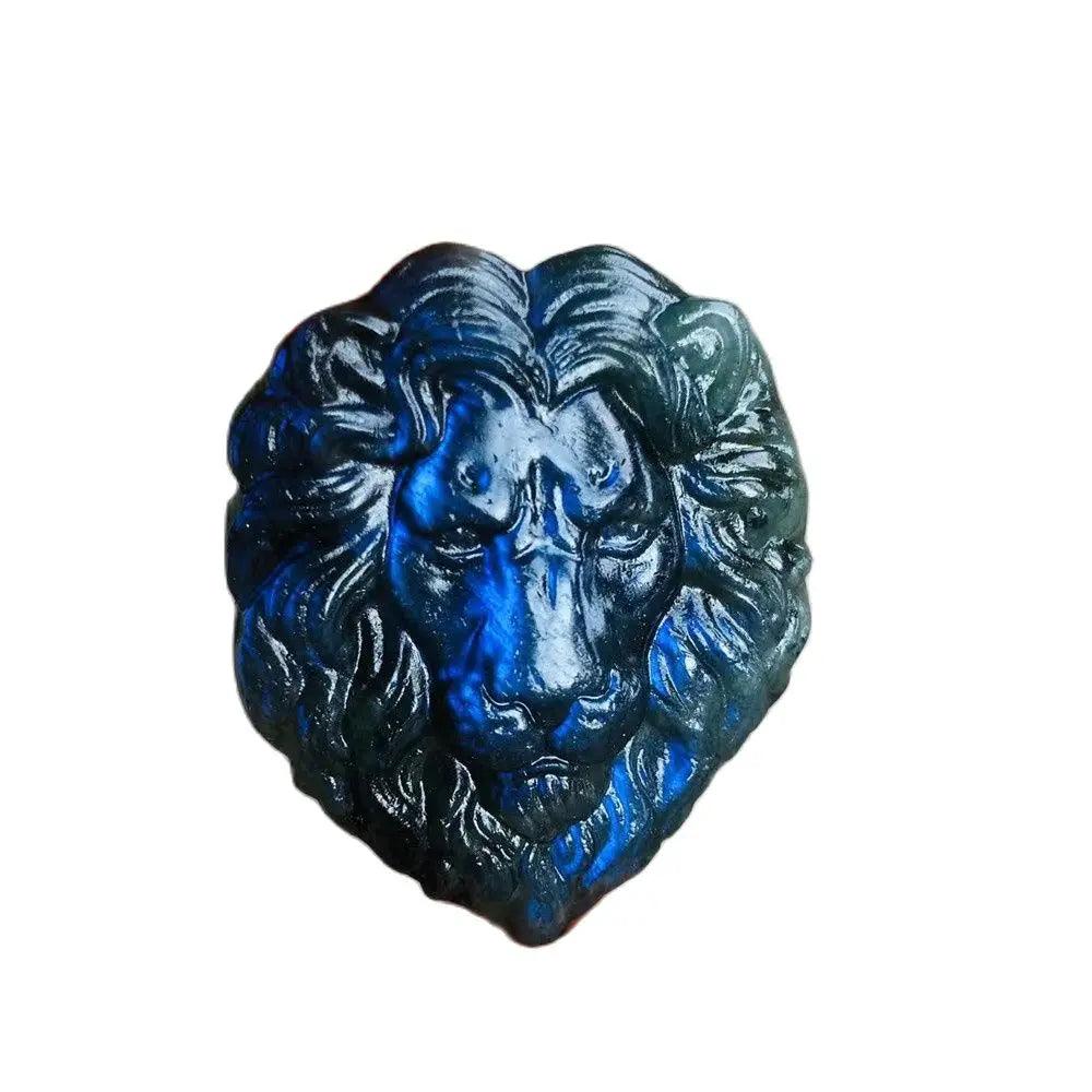 Polished labradorite crystal carved into a lion's head, displaying iridescent blue and green flashes.