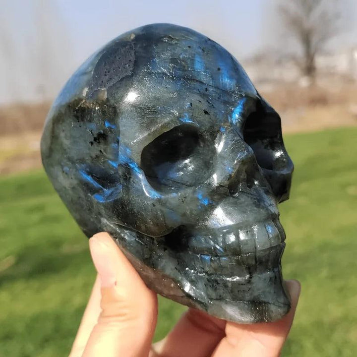 Labradorite crystal carved skull with iridescent blue flash for intuition and magic.