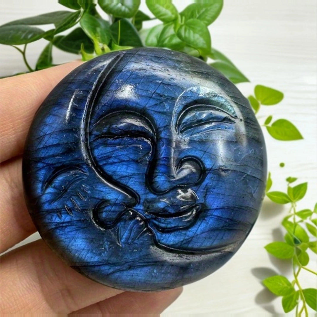 Shimmering blue labradorite crystal moon and sun carving, symbolizing intuition and clarity.