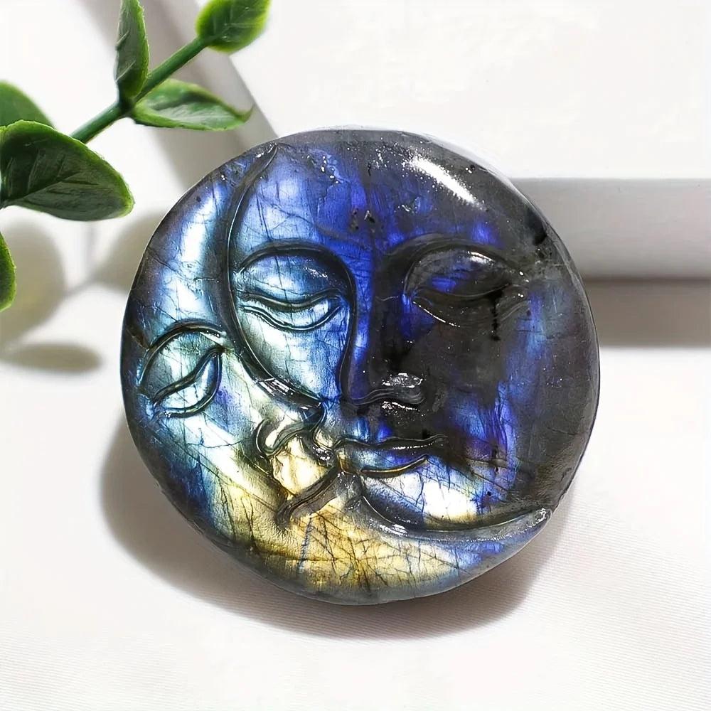 Iridescent blue and gold labradorite crystal carving featuring a sleeping moon and sun design.