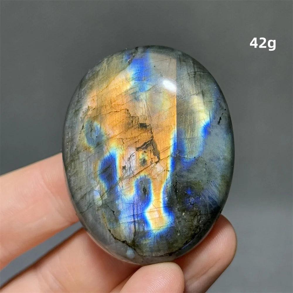 Captivating Labradorite Crystal Polished Palm Stone with vivid blue, gold, and green labradorescence for protection and growth.