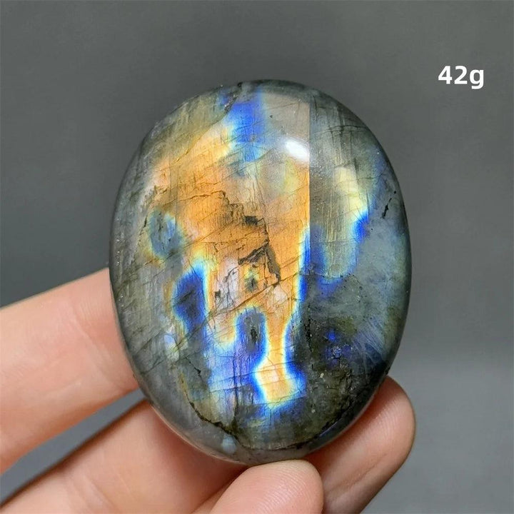 Captivating Labradorite Crystal Polished Palm Stone with vivid blue, gold, and green labradorescence for protection and growth.