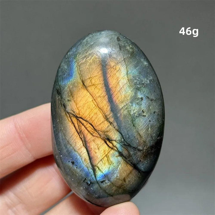 Captivating Labradorite Crystal Polished Palm Stone with vivid blue, gold, and green labradorescence for transformation.