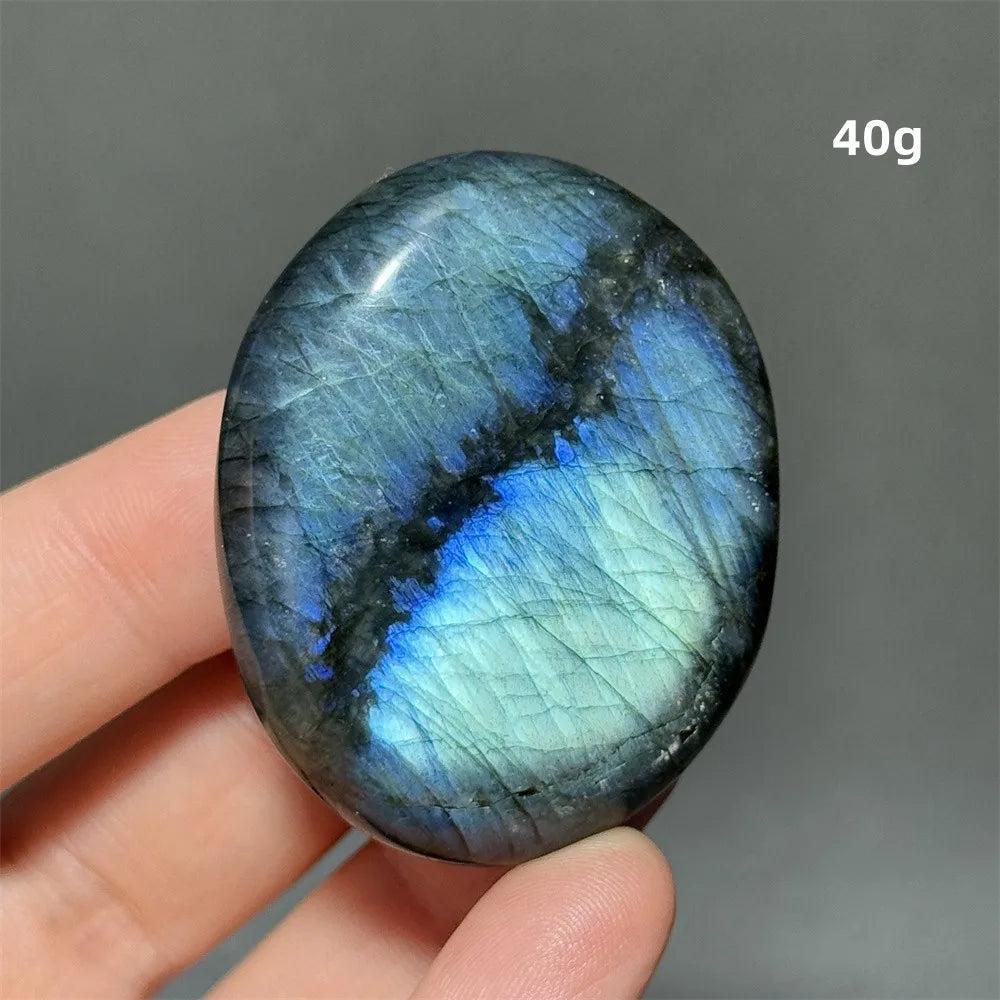 Captivating Labradorite Crystal Polished Palm Stone with vivid blue and green labradorescence, perfect for meditation and display.