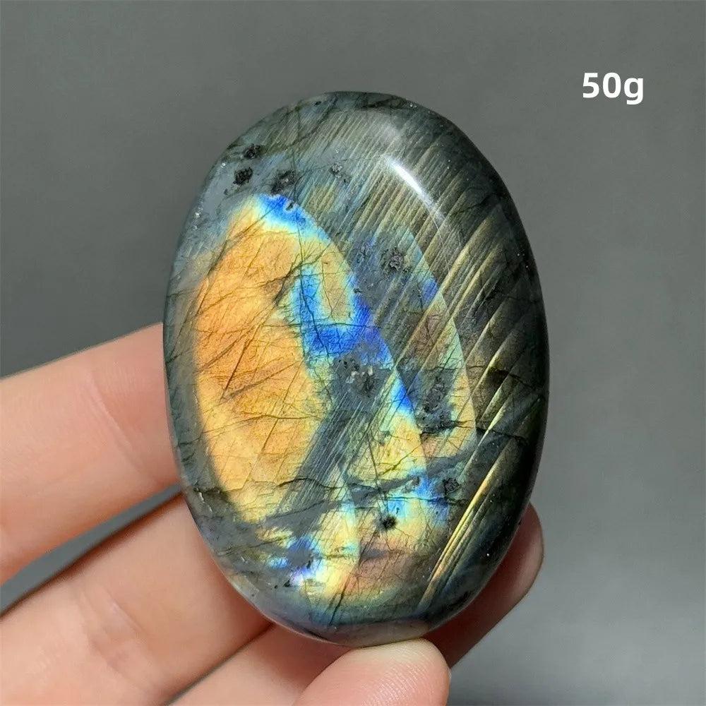 Captivating Labradorite Crystal Polished Palm Stone with vivid blue, gold, and green labradorescence, ideal for transformation.