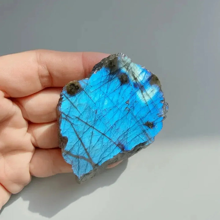 Natural Labradorite crystal rough slice featuring vibrant blue flash for Third Eye and Throat Chakra energy work.