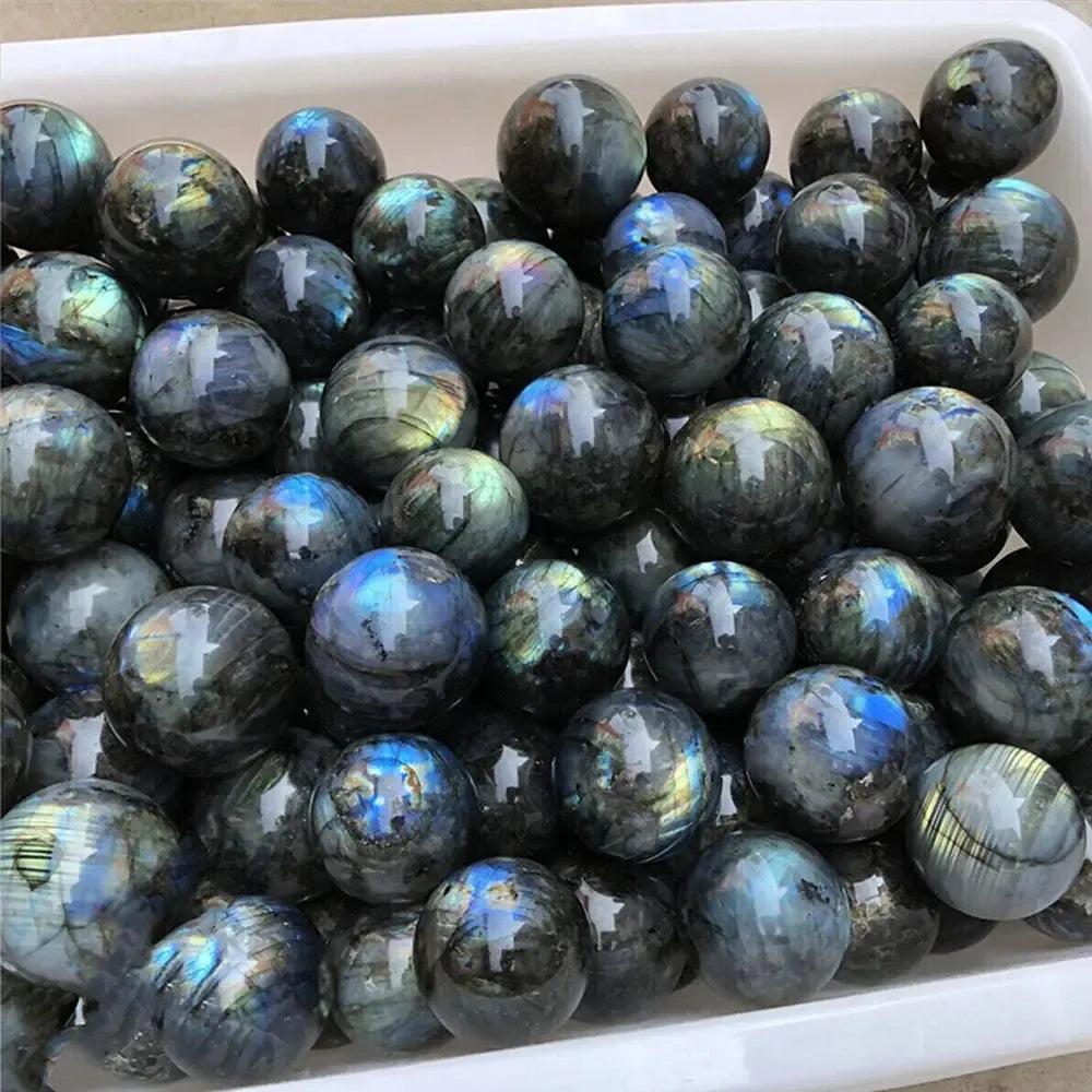 Polished Labradorite crystal spheres with iridescent blue, green, and gold flashes, radiating mystical energy from Crystal Destiny.