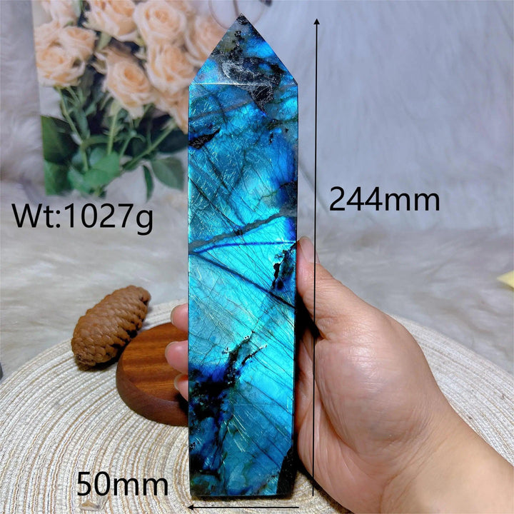 Polished Labradorite crystal tower, 244mm tall, showing vivid blue-green labradorescence and dark inclusions.