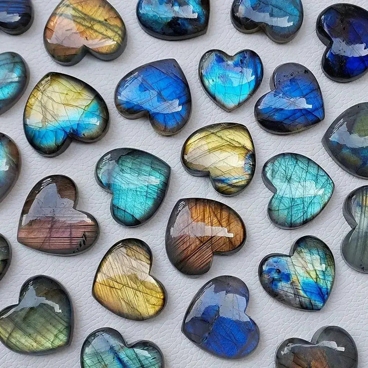 Iridescent blue, gold, and green Labradorite heart carvings from Crystal Destiny, showcasing mystical flashes.