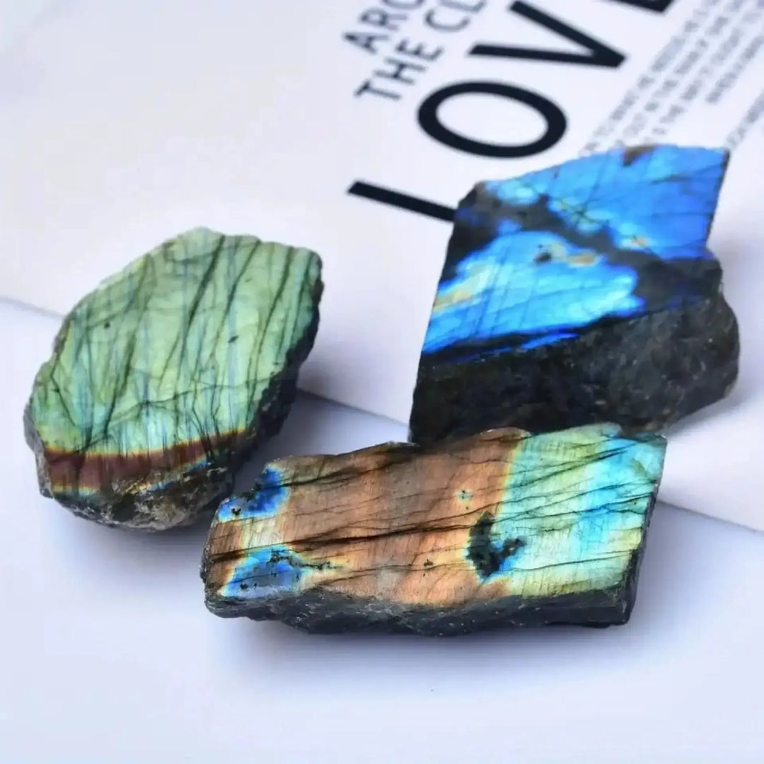 Natural rough Labradorite slices featuring vibrant blue and gold iridescent flashes for healing and office decor.