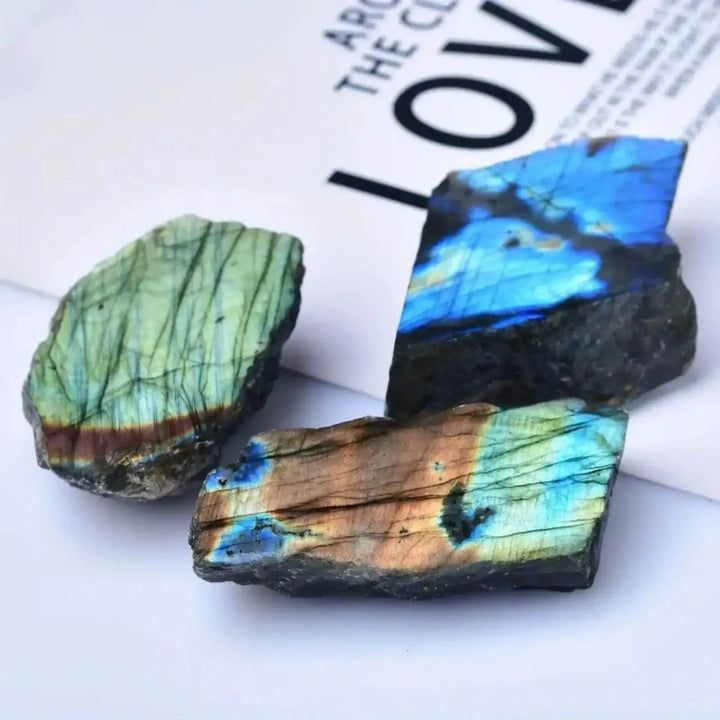 Natural rough Labradorite slices featuring vibrant blue and gold iridescent flashes for healing and office decor.