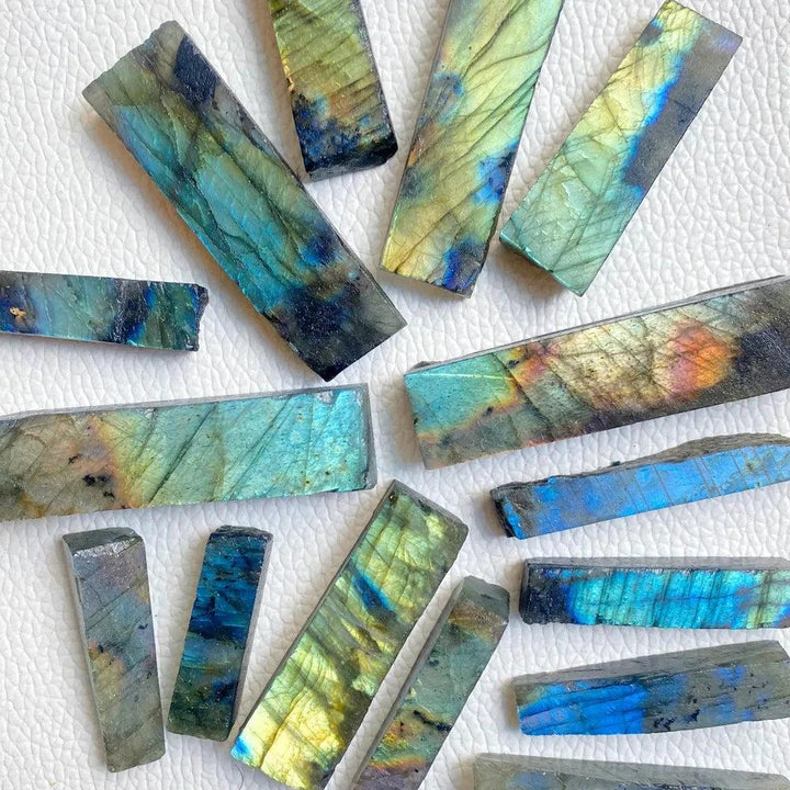 Raw Labradorite crystal sticks featuring vibrant blue, gold, and green spectral flashes for Third Eye Chakra healing.