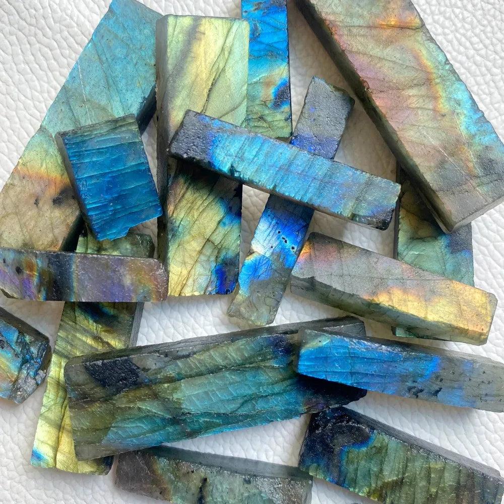 Raw labradorite crystal sticks featuring vibrant blue, gold, and green spectral flashes for Third Eye Chakra healing.