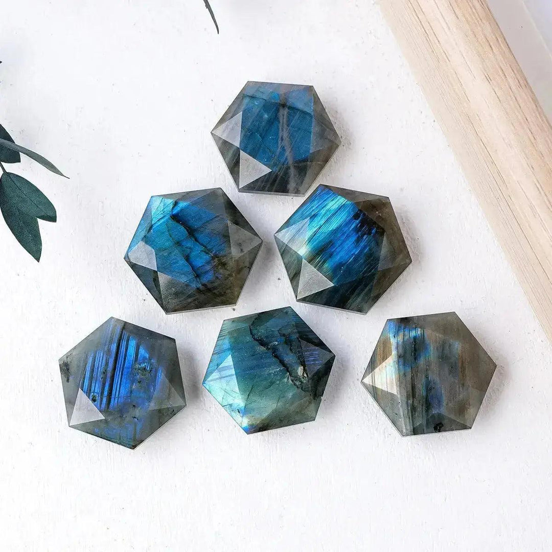 Six iridescent blue and green Labradorite hexagonal crystals from Crystal Destiny, showcasing mystical flashes.