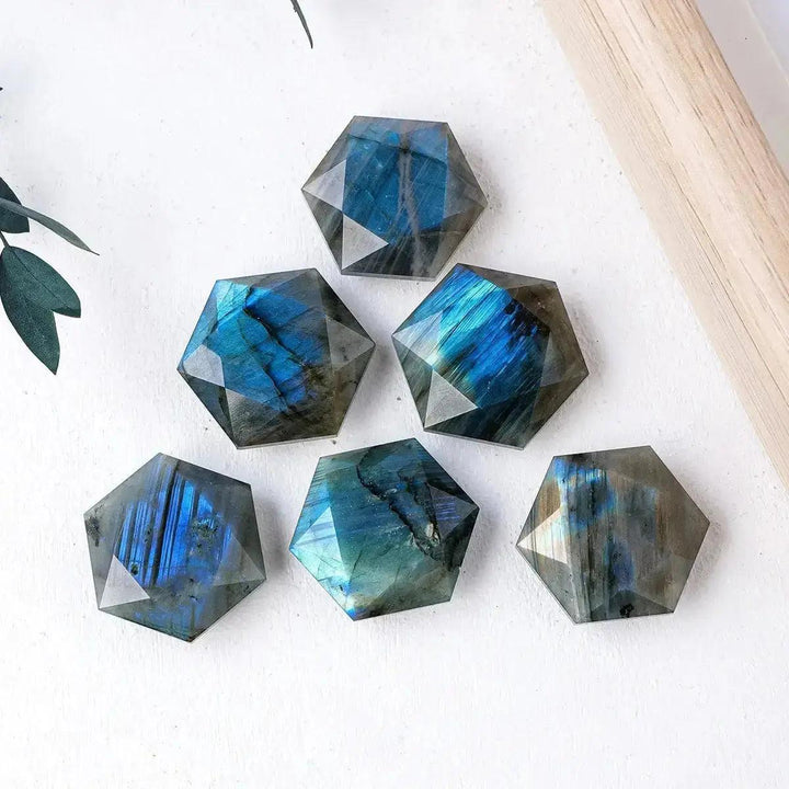 Six iridescent blue and green Labradorite hexagonal crystals from Crystal Destiny, showcasing mystical flashes.