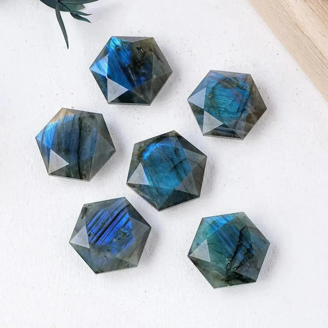 Six iridescent blue and green Labradorite hexagonal crystals from Crystal Destiny, showcasing their unique flash.
