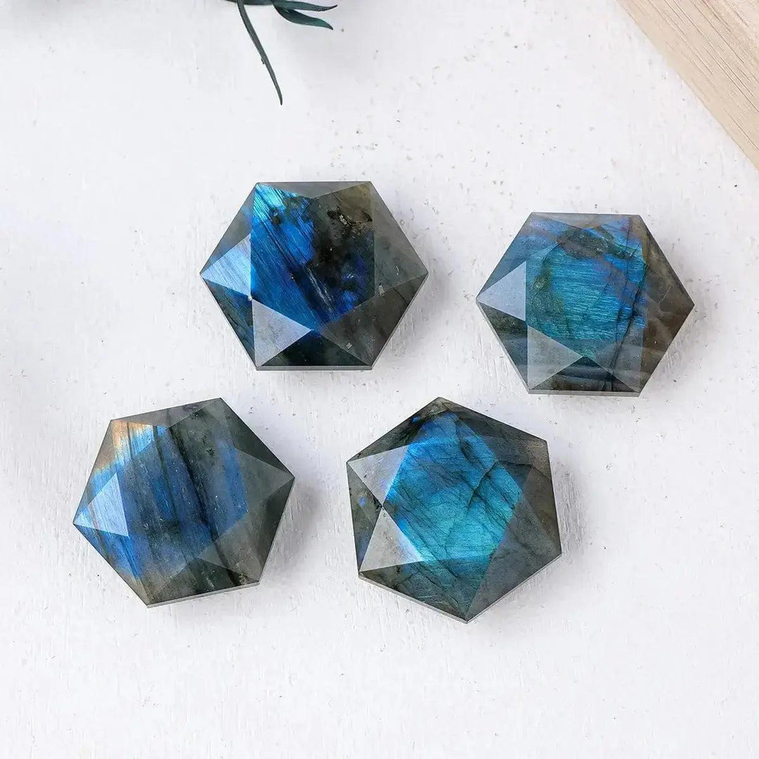 Four iridescent blue and green Labradorite six-pointed star crystals from Crystal Destiny, enhancing intuition.