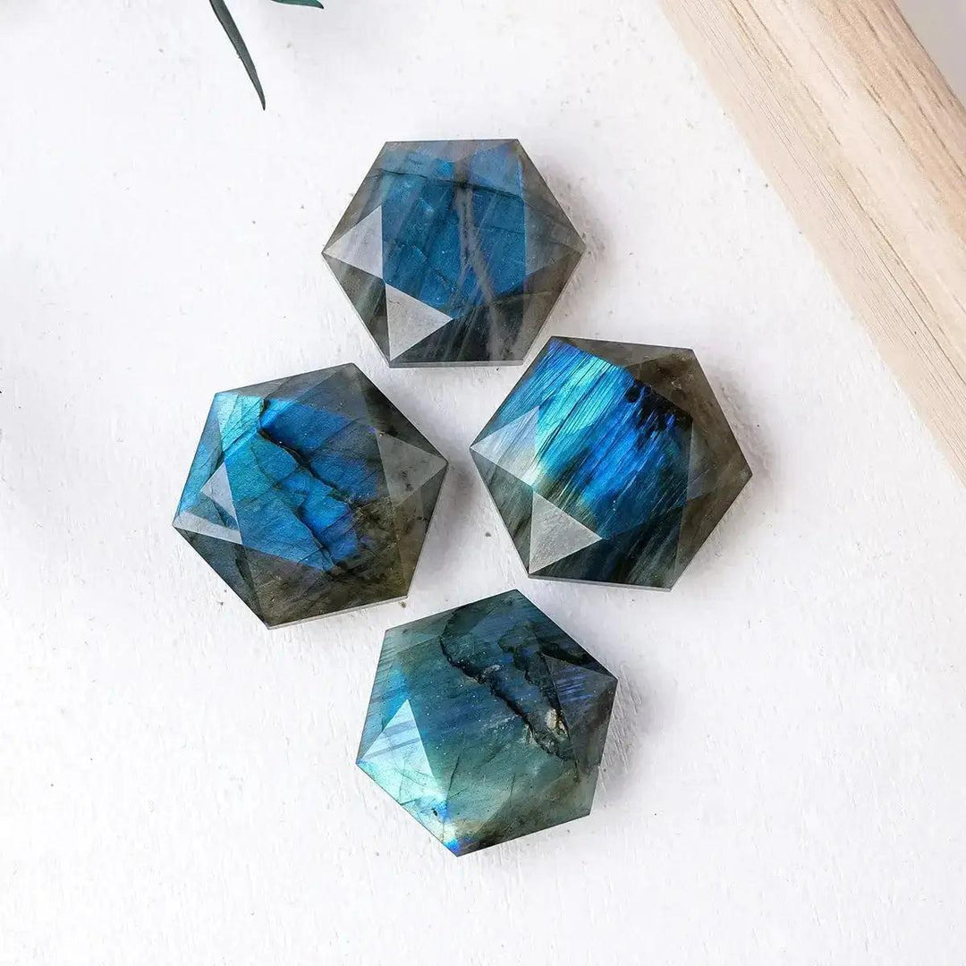 Four faceted Labradorite hexagonal crystals with iridescent blue and green flashes from Crystal Destiny.