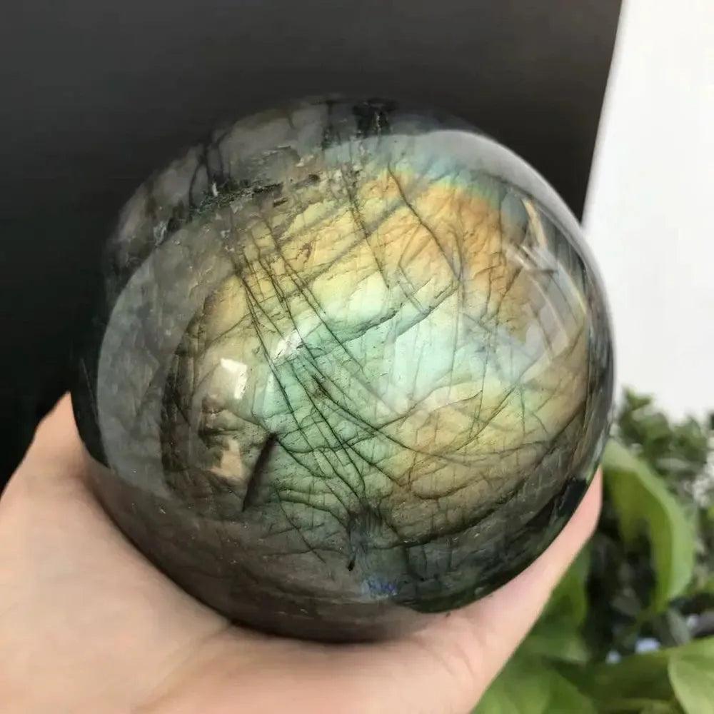Polished Labradorite sphere from Crystal Destiny, showcasing iridescent blues, greens, and golds for intuition and protection.